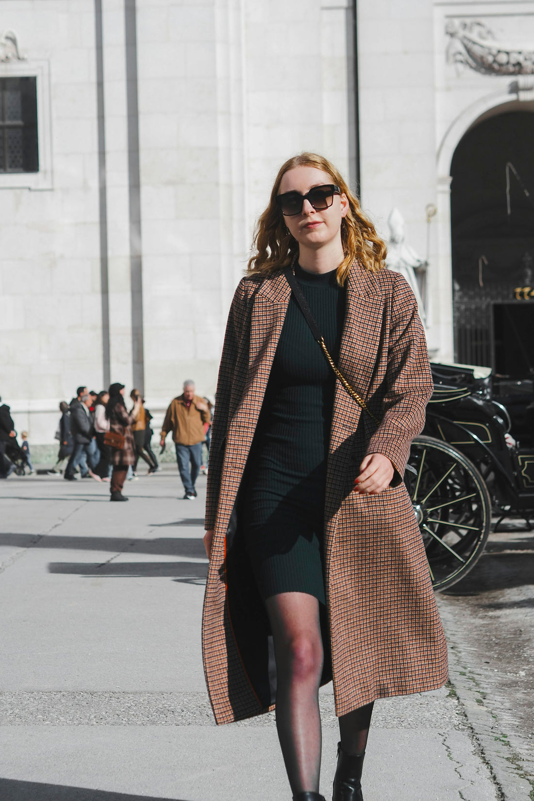 Woman in a long coat walking down the street